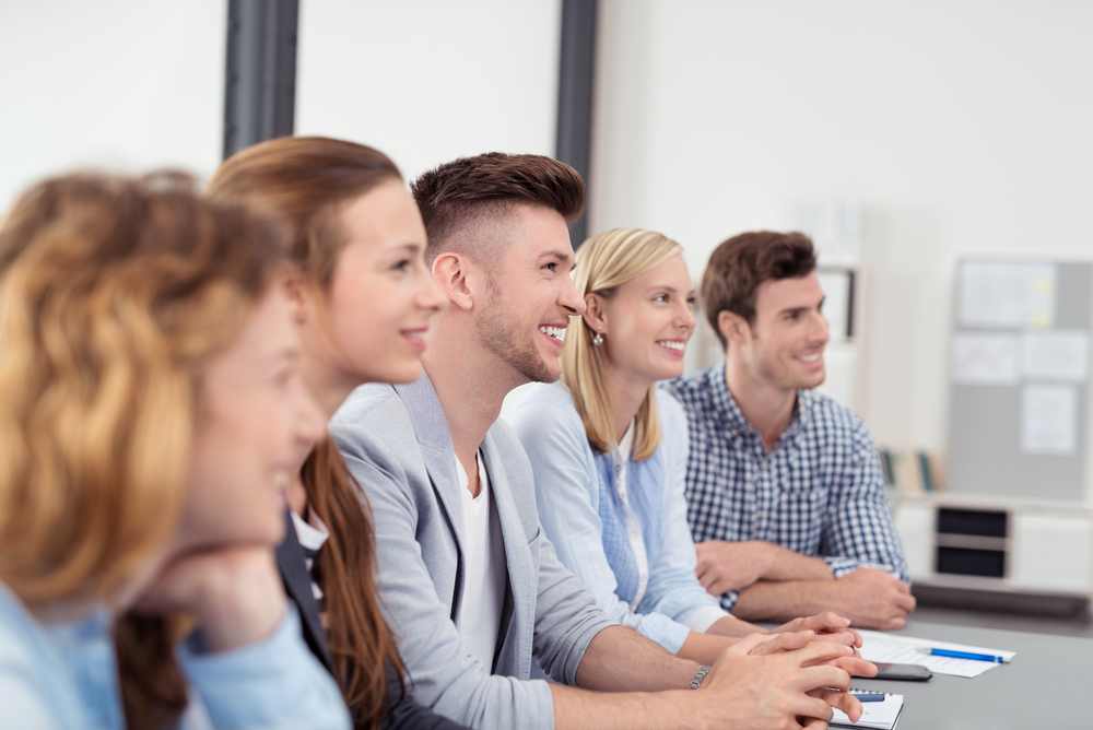 Young Office People with Happy Facial Expressions Listening to Someone Discussing to them Inside the Office